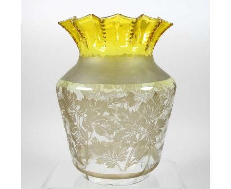 A yellow and clear glass oil lamp shade, with a frilled rim, etched with flowers, 22cm high Condition report: 10cm aperture. 