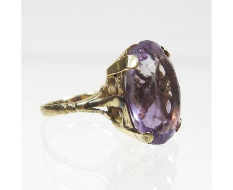 A large unmarked amethyst cushion cut single stone ring, 6.6g gross, size N/O, approximately 19 x 13mmCondition report: Stone