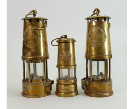 Two Eccles Type 6 brass Miners lamps : and a smaller Welsh novelty musical miners lamp. (3) 