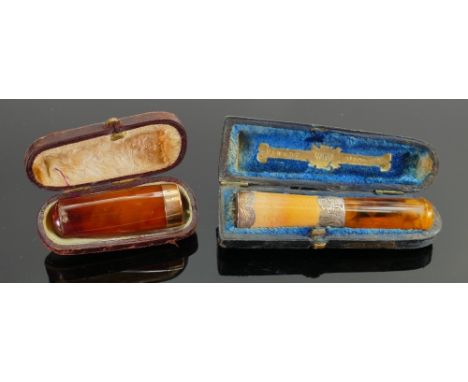 Two vintage cigar holders: one with 9ct gold collar and the other with silver collar, both with ordinal boxes. (2) 