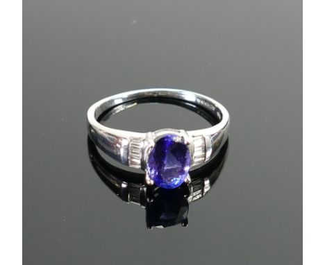 18ct white gold ladies ring :set with oval cut blue tanzanite stone surrounded by diamonds, ring size Q,3.9g. (with Anchor Ge