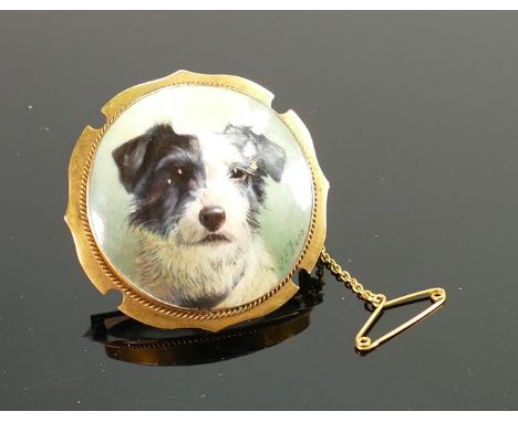 Yellow metal brooch with portrait of a terrier by J E Dean, tested to be 15ct gold,11.1g. J E Dean was a Minton artist from 1