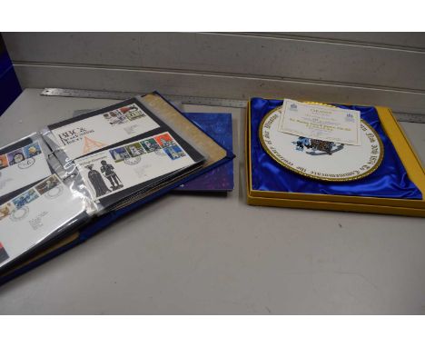 A album of first day covers together with a Churchill collectors plate and an album of commemorative coins