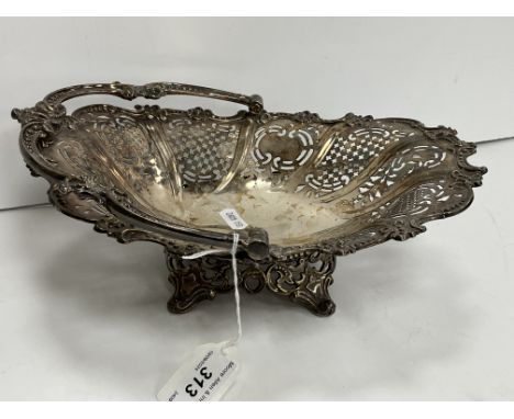 A Victorian silver pierced swing handled fruit basket raised on four scrolling feet (by Henry Wilkinson & Co, Sheffield 1859)