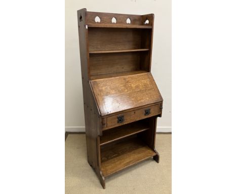 A circa 1900 oak student's bureau, the three quarter galleried two shelf super structure with inverted love heart motifs over