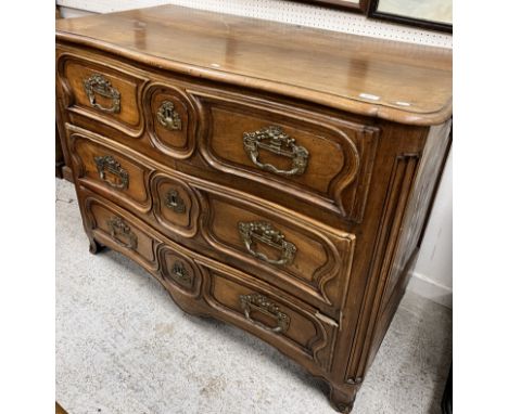 A 19th Century French walnut commode in the Louis XV manner, the plain top with moulded edge over three fielded panelled serp