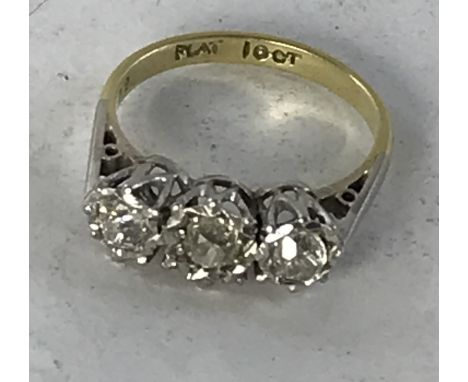 An 18 carat gold and platinum illusion set three stone diamond ring, each of the stones approx. 0.15 carat, ring size L, 2.8 