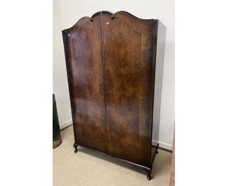 An early to mid 20th Century burr walnut veneered and cross banded double wardrobe in the Georgian style, the two doors openi