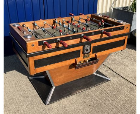 A mid 20th Century stained beech and ebonised table football game in the Art Deco taste, on a tapered rectangular plinth base