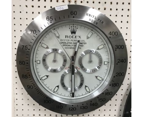 A Rolex dealer's display wall clock, the bezel with units per hour, etc., the dial with three subsidiary dials and plain bato