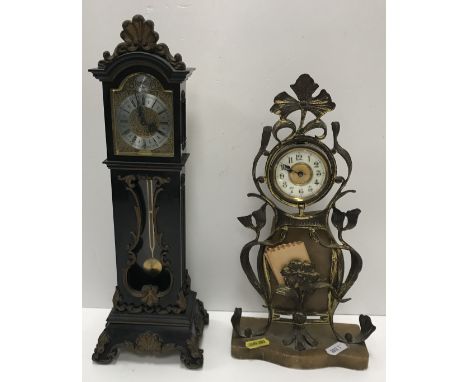 A circa 1900 Continental Art Nouveau gilt brass cased mantel clock with scrolling foliate and floral decoration, the porcelai