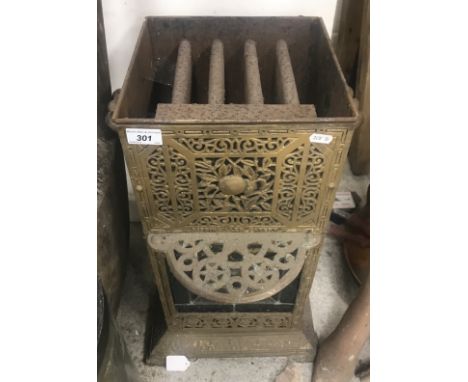 A Victorian gold painted iron greenhouse heater with leaded glazed panel, a wooden trug, child's painted metal push-along cha