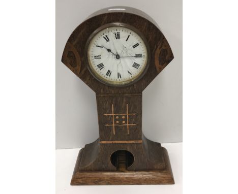 A circa 1910 French oak and inlaid cased mantel clock in the Art Deco / Seccessionist manner, the movement by R & Co. of Pari