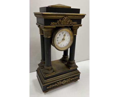 A 19th Century French bronze and gilt bronze portico mantel clock of architectural form, the movement of drum form with circu