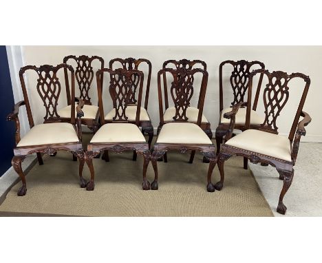 A set of eight modern mahogany Chippendale style dining chairs with pierced back splats and upholstered drop in seats on carv