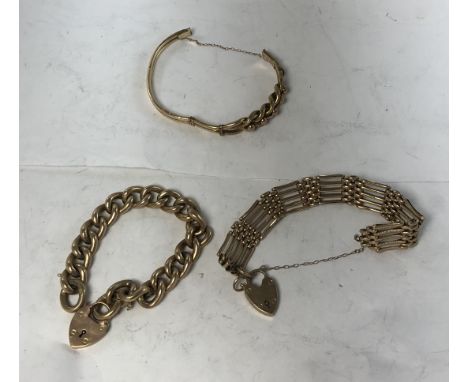 A 9 carat gold large link bracelet with love heart locket together with a 9 carat gold gate link bracelet with love heart sha