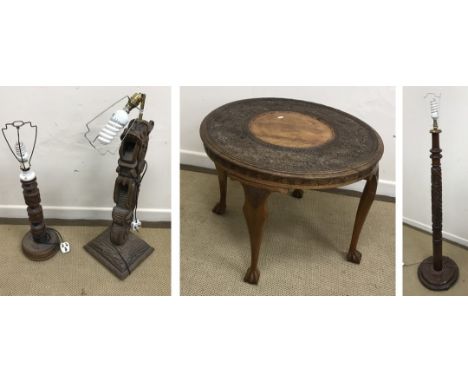 A mid 20th Century Burmese carved teak circular occasional table with all-over floral and foliate decoration, raised on cabri