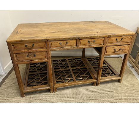 A Chinese pine and walnut desk, the top cross banded over two central short drawers flanked by two further pairs of short dra
