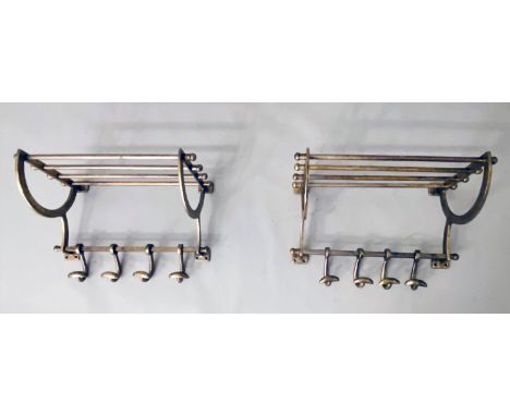 WALL MOUNTING LUGGAGE RACKS, a pair, with a run of coat hangers to base, gilt metal. (2) 