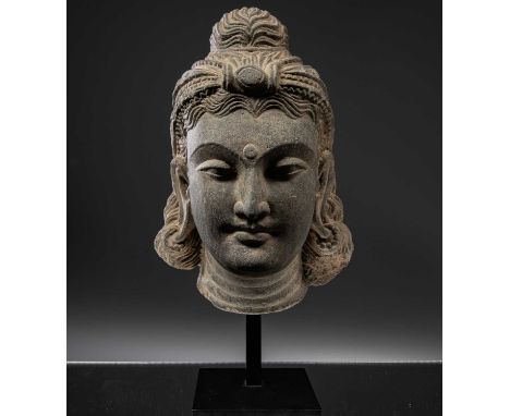 Grey schistGandhara 4th century   Dimensions: Height 31 cm Wide 17 cm Depth 13 cm with baseWeight: 6220 grams with base Elega