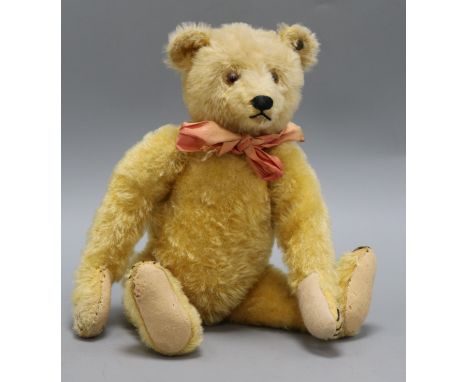 A 1920's Steiff teddy bear, Rachel, with golden mohair, brown and black glass eyes, pronounced muzzle, black stitched nose, m