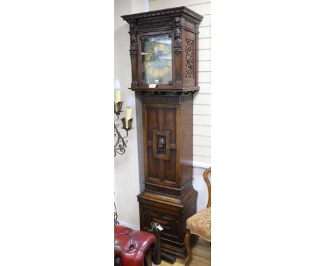 An Edwardian Maples oak cased quarter chiming longcase clock