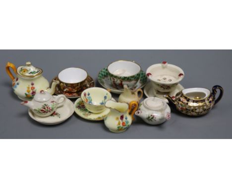 A collection of miniature teawares, including Royal Crown Derby, Worcester, Crown Staffordshire