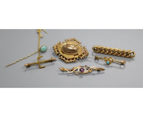 Five assorted yellow metal brooches including gem set and a stick pin.
