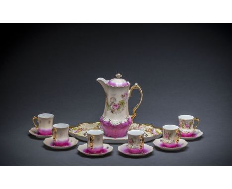 GERMAN PARCEL GILT FOLIATE DECORATED PORCELAIN TEA SERVICE Circa 1900, the undersides marked Germany with a crown, comprised 
