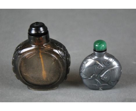 CHINESE CARVED HEMATITE SNUFF BOTTLE WITH FISH MOTIF & ANOTHER With contrasting stopper, 2Oth century, together with a glass 