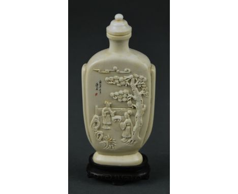 FINE AND LARGE CHINESE CARVED IVORY SNUFF BOTTLE Of elongated ovoid form with rounded shoulders, finely carved with ladies un