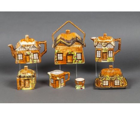 ENGLISH "YEA OLDE COTTAGE" SEVEN-PIECE CERAMIC TEA AND COFFEE SERVICE Circa 1900, probably Staffordshire, each piece modeled 