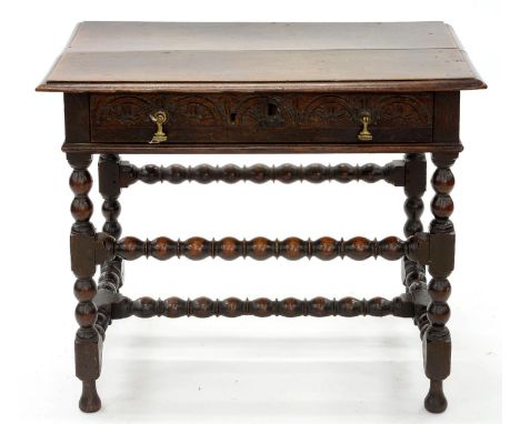 A WILLIAM III OAK SIDE TABLE, THE DRAWER CARVED WITH LUNETTES, BRASS HANDLES, ON BOBBIN TURNED LEGS UNITED BY STRETCHERS, 72C