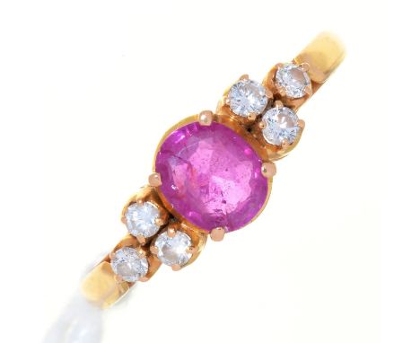 A RUBY AND DIAMOND RING, THE LARGER CUSHION SHAPED RUBY FLANKED BY CLUSTERS OF THREE DIAMONDS TO THE SHOLDERS, IN GOLD MARKED