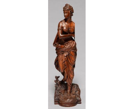 A FRENCH FRUITWOOD STATUETTE OF A WOMAN, 19TH C, IN DIAPHANOUS DRAPERY, ARMBAND AND SANDALS, ON&nbsp; ROCKY BOW CENTRED BASE 