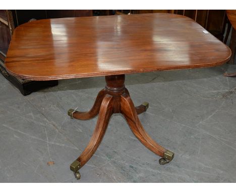 AN EARLY VICTORIAN MAHOGANY BREAKFAST TABLE, THE TIP-UP OBLONG TOP ON BULBOUS PILLAR AND QUADRUPLE LEGS WITH BRASS CASTORS, 7