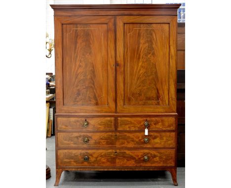 A GEORGE IV MAHOGANY AND LINE INLAID LINEN PRESS, C1830, WITH CAVETTO CORNICE, ENCLOSED BY A PAIR OF FLAMED FIGURED PANELLED 