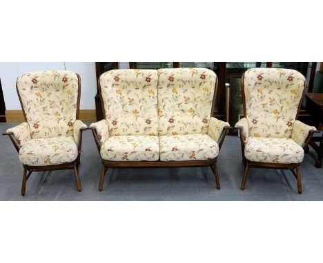 AN ERCOL STAINED ASH THREE PIECE SUITE, COMPRISING SOFA, 140CM W AND PAIR OF ARMCHAIRS Overall good clean solid condition wit