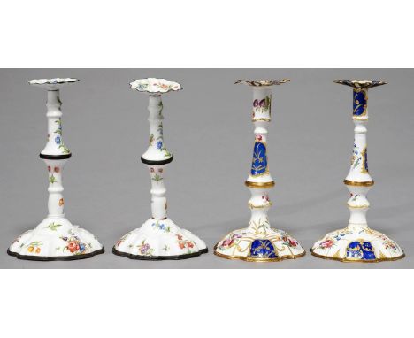 TWO PAIRS OF ENAMEL CANDLESTICKS, LATE 19TH C, IN LATE 18TH C ENGLISH STYLE, PAINTED WITH SPRAYS AND SCATTERED FLOWERS, ONE B