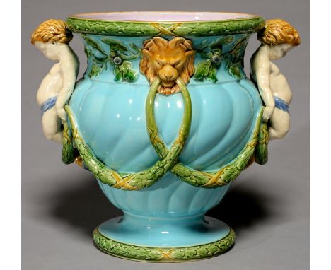 A MINTONS SPIRALLY LOBED OGEE MAJOLICA JARDINIERE, C1870, WITH HORN HANDLE AND APPLIED WITH FESTOONS HANGING FROM LION MASKS 