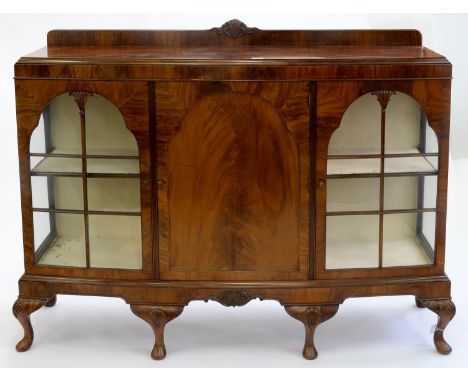 A BOW FRONTED MAHOGANY CHINA CABINET, C1920, THE CENTRAL CUPBOARD FOR SHEET MUSIC ENCLOSED BY A FIGURED-PANEL DOOR, 127CM H; 