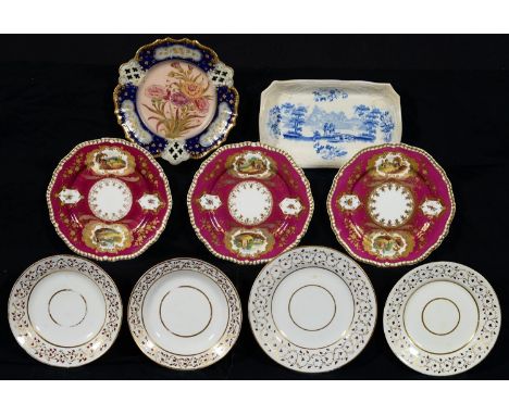 A SET OF THREE SPODE GADROONED CLARET GROUND DESSERT PLATES, 1822-33, PAINTED WITH LANDSCAPE RESERVES IN LEAFY RAISED GILT FR