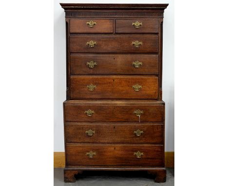 A GEORGE III OAK CHEST ON CHEST, WITH DENTIL CORNICE AND BLIND FRET FRIEZE, FITTED TWO SHORT AND THREE GRADUATED MOULDED DRAW