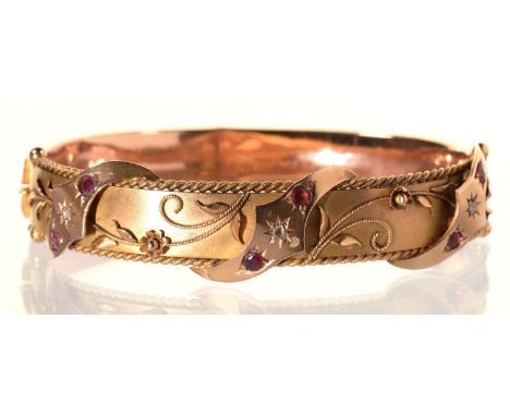 A RUBY AND DIAMOND BANGLE, GIPSY SET AND APPLIED WITH FILIGREE, IN 9CT GOLD, 57 X 71MM, MAKER S BROS OVERSTRUCK ON ANOTHER'S 