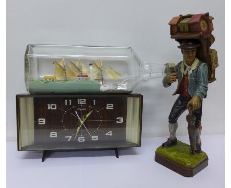 A German figure, a ship in a bottle and a mantel clock, clock a/f