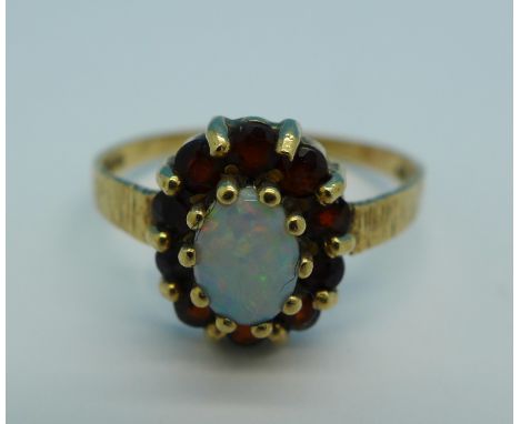 A 9ct gold, opal and garnet ring, 2.1g, R