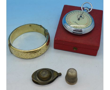 An eyeglass/compass, a silver thimble, a plated bangle and a stopwatch