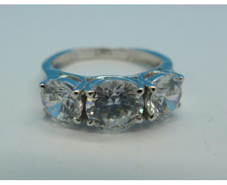 A three stone moisonite ring set in white metal marked 14kt, 3.9g, M