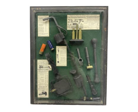 Wall hanging display case containing hunting ephemera to include cartridge boxes, snares, gun cleaning equipment etc