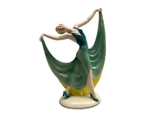 Early 20th century Hertwig Katzh�tte figure of an Art Deco lady dancing, wearing a green, blue and yellow dress, stood upon o